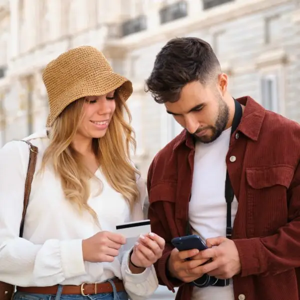 Young Caucasian couple buying the tour tickets to visit Madrid, Spain.